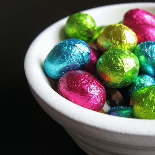 candy chocolate eggs in white bowl confectionery