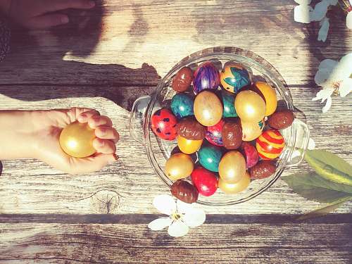 egg bowl of assorted-color Easter eggs person