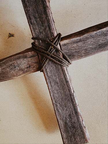 blade brown rope on brown wooden post sword