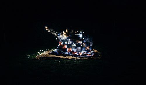a small house in the dark with lights on it