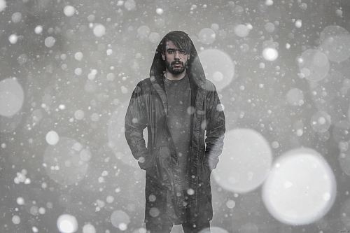bokeh photography of man wearing coat