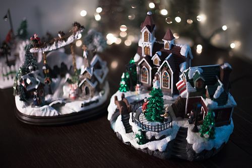 brown and white miniature house on brown wooden plank