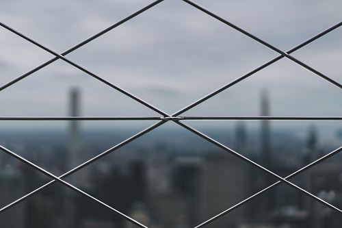 closeup photo of gray metal mesh-link fence