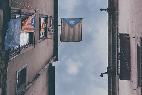 symbol blue white and red flag on black steel pole during daytime grey
