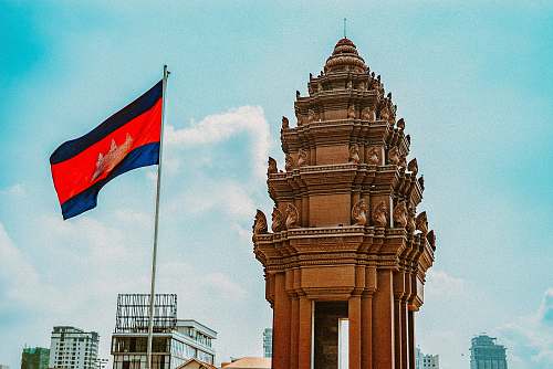 symbol brown concrete building with flag of us a during daytime phnom penh