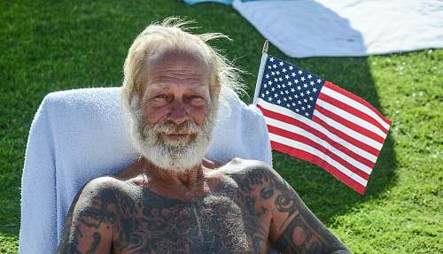 human man with tattoo sitting on chair skin