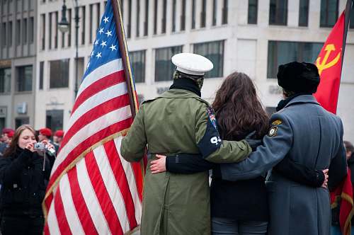 symbol two men and woman standing behind of U.S. flag human
