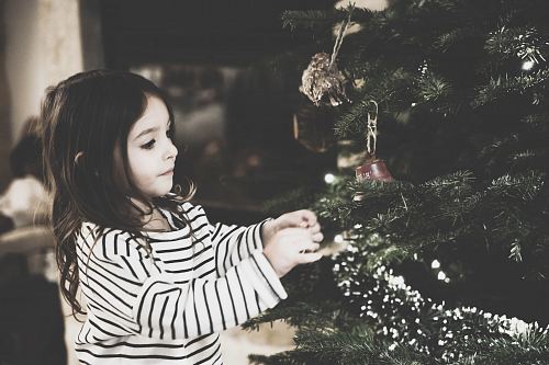 girl decorating the Christmas tree