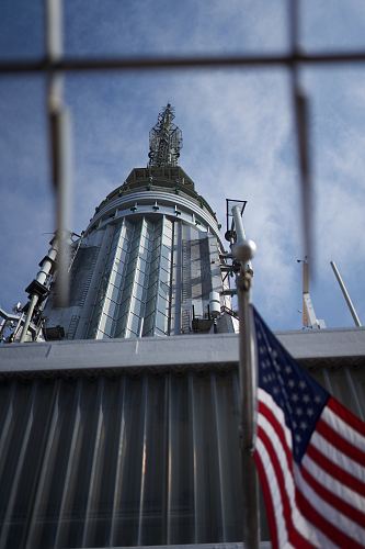 low-angle photography of gray building by USA flag