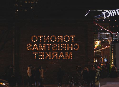 people standing beside Toronto Christmas market building