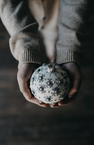person holding bauble ball