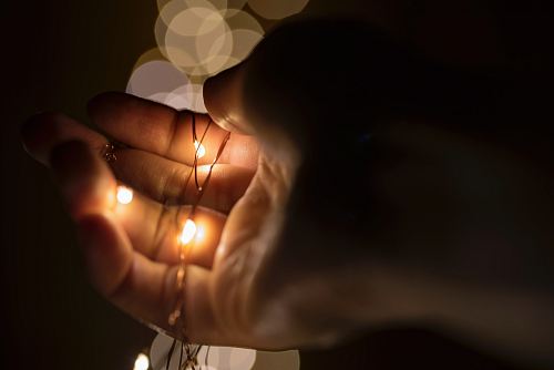 person holding lace with yellow lights