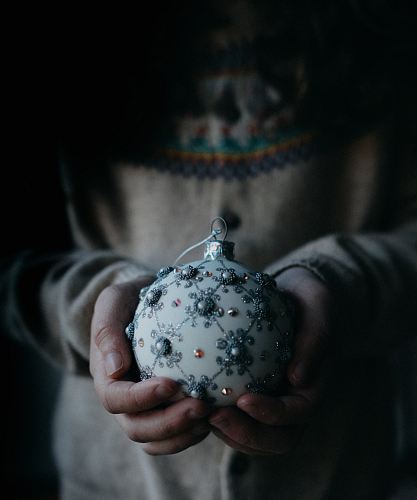 person holding white and grey ornament