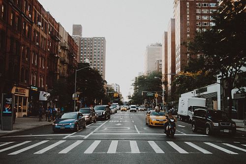 photo of cars on road near city building