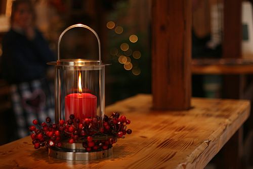 red lighted candle on brown wooden frame