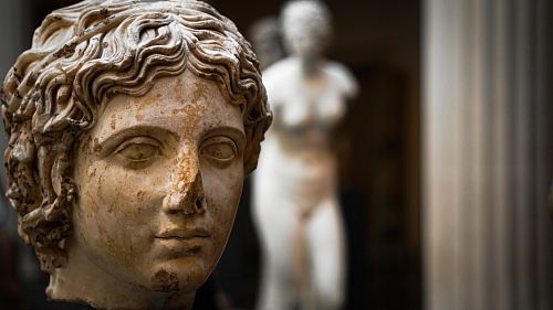 selective focus photography of woman statue