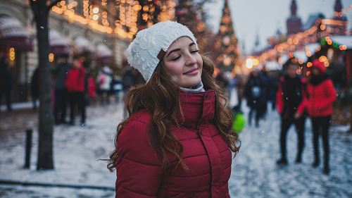 selective focus photography of woman wearing red parka jacket while standing