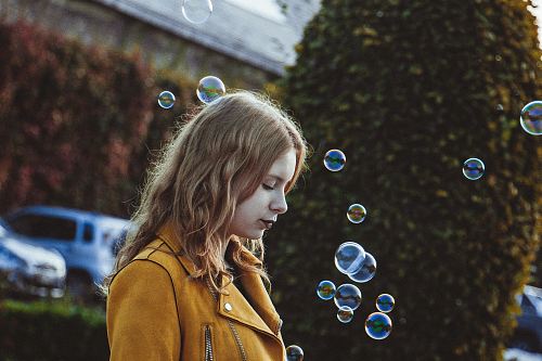 selective focus photography of woman with bubbles