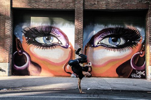 shallow focus photo of man doing hand stand