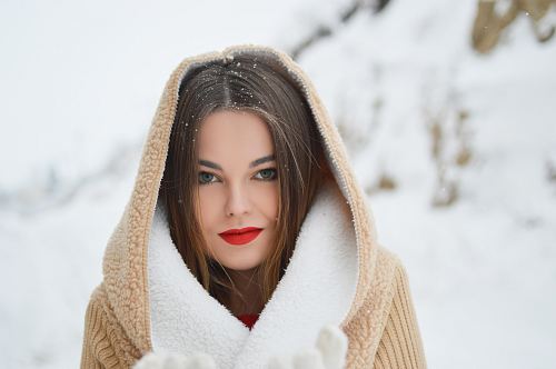 smiling woman with winter coat during daytime
