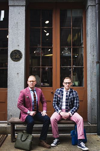 two man in formal suit sitting on bench chair