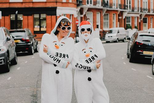two women wearing coveralls standing next to each other