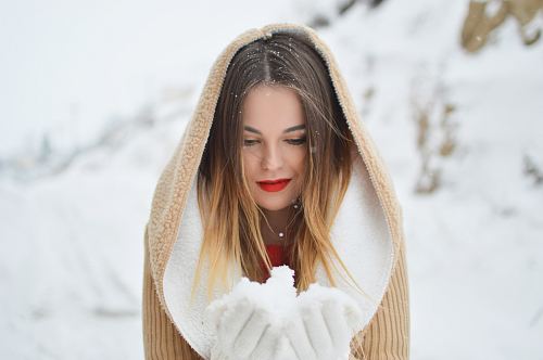 woman holding and looking at ice during daytime