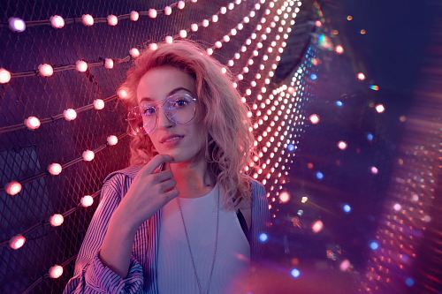 woman standing near string lights