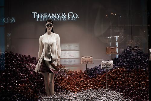 woman standing surrounding assorted-color balls