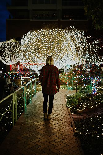 woman wearing brown jacket at night