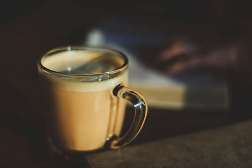 cup clear glass mug filled with brown liquid mug