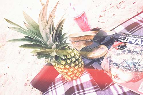 fruit pineapple beside phone and speaker pineapple