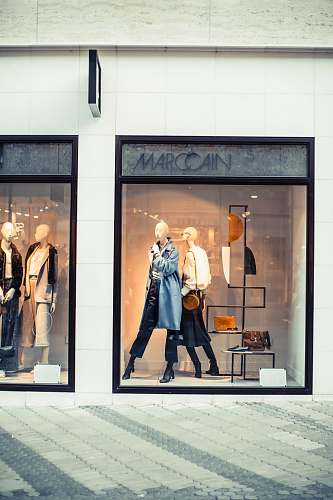 person display of mannequins with dresses inside the building shop
