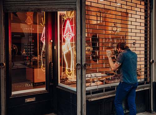 person man standing in front of structure shop