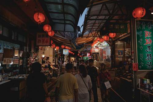 person people standing near red lanterns market