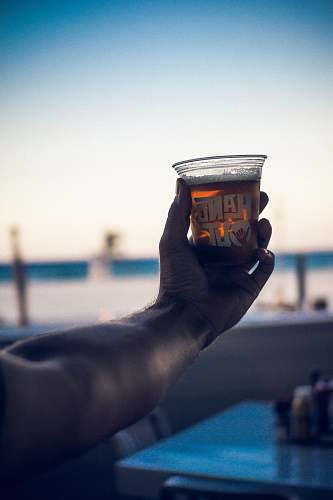 beer person holding cup of beverage drink