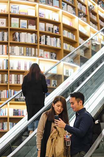 person woman looking at man's phone indoors
