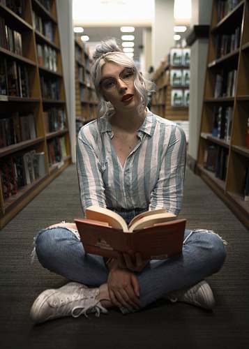 furniture woman sitting near book rack book
