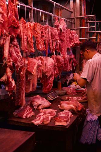 human man chopping meat butcher shop
