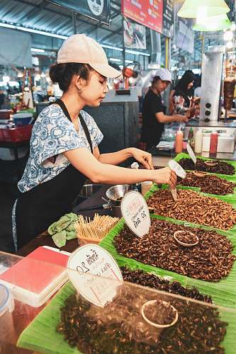 human woman beside tray of foods clothing