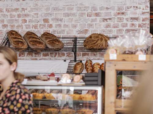 person bread on black metal display rack bakery