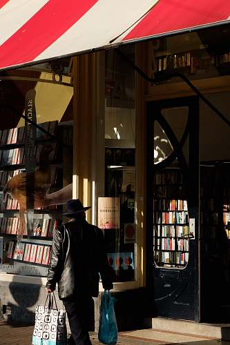 indoors man standing beside store facade furniture
