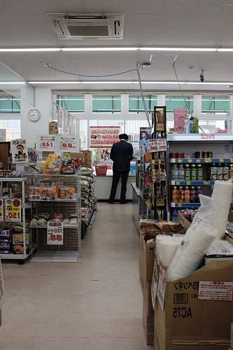 human man standing on store counter during daytime person