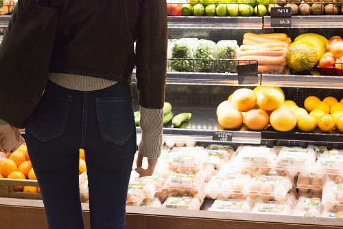human woman standing front of vegetables and fruits person
