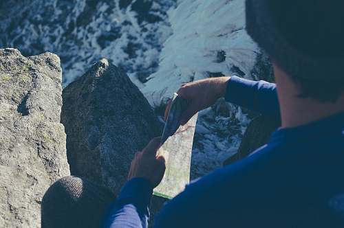 climbing person holding map mountain