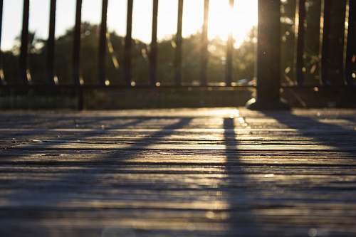 wood black fence against the light sun