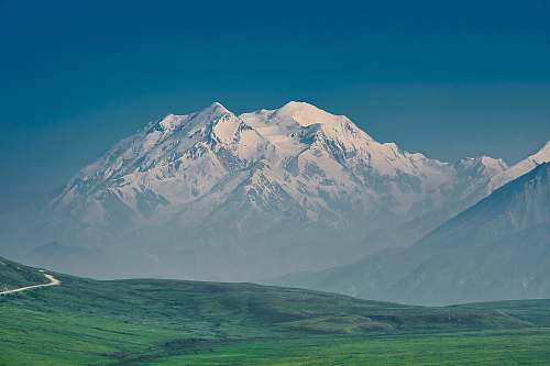 nature grass field and glacier mountain mountain range