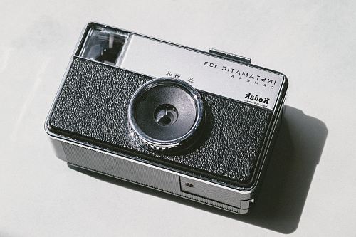 black and gray Kodak camera on white surface