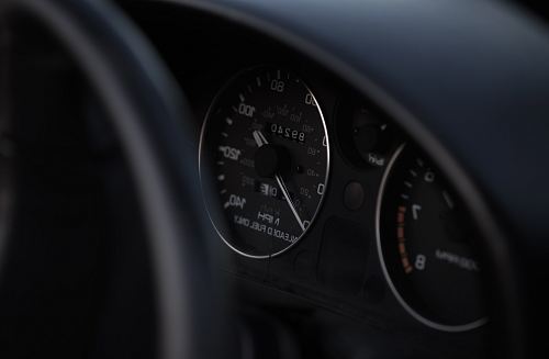 black vehicle speedometer
