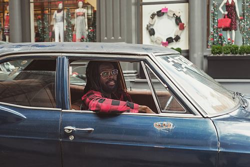 man driving blue car